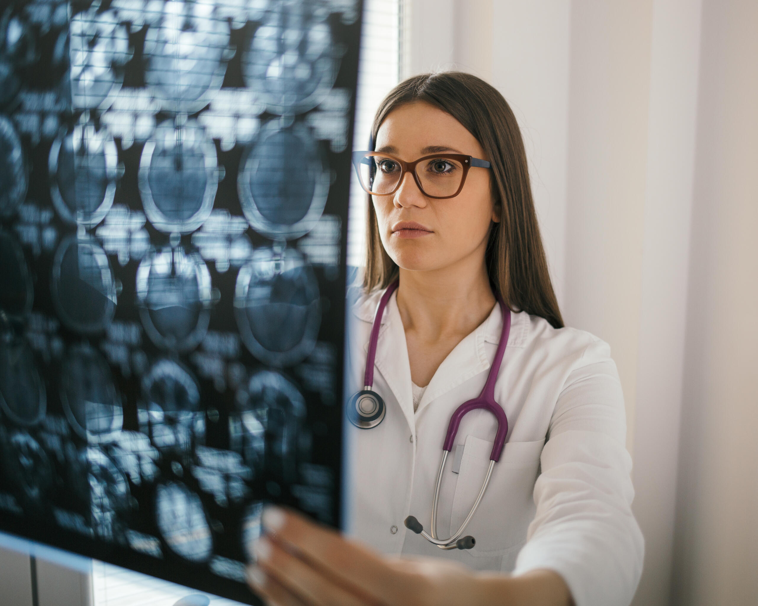 Female doctor looking at x-ray image