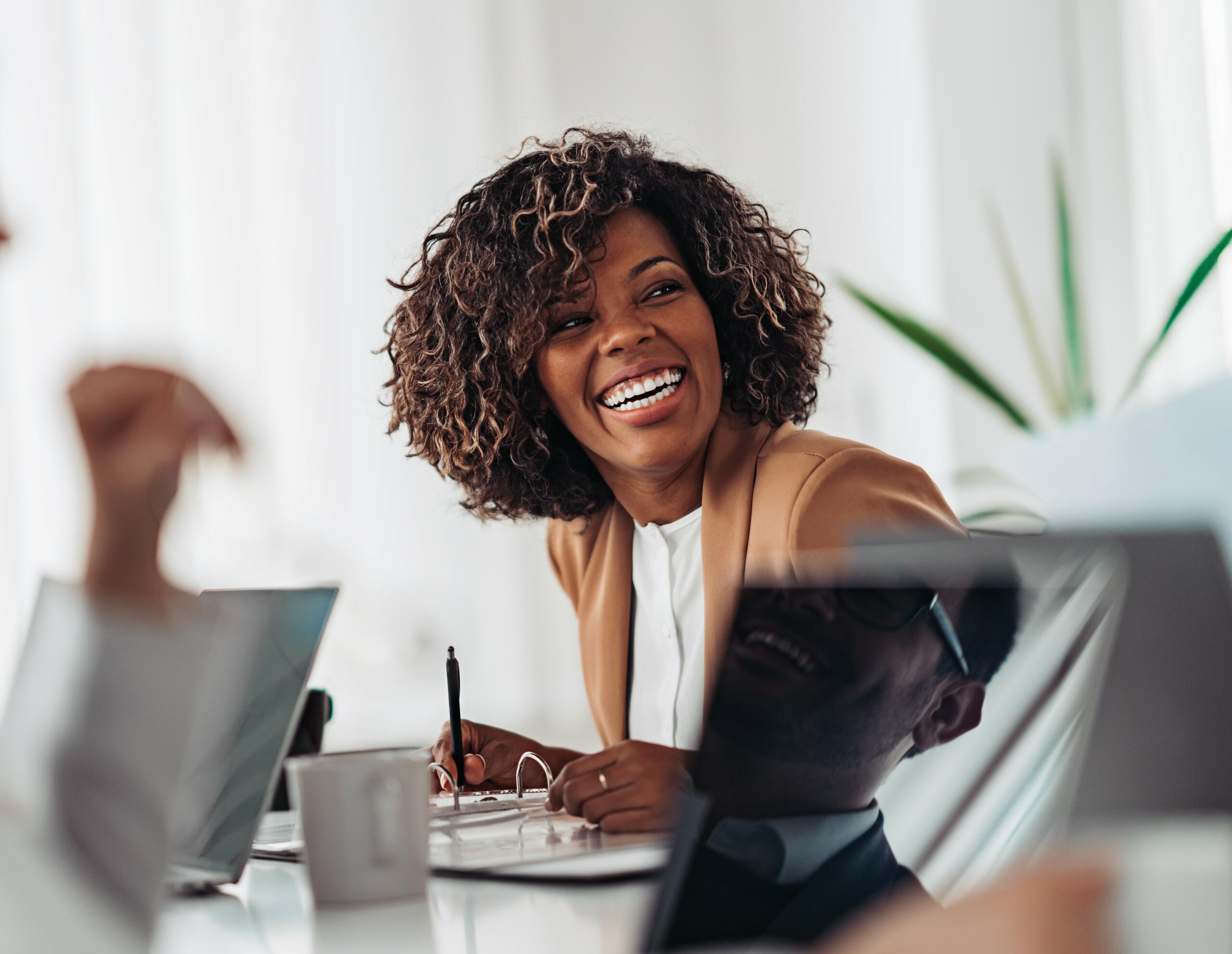 Portrait of cheerful business woman smiling at the meeting