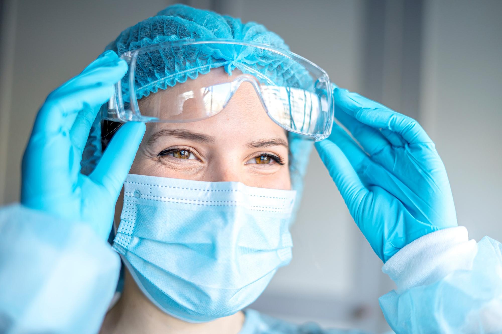 Happy Medical Surgical Doctor and Health Care, Portrait of Surgeon Doctor in PPE Equipment on Isolated Background. Medicine Female Doctors Wearing Face Mask and Cap for Patients Surgery Work.